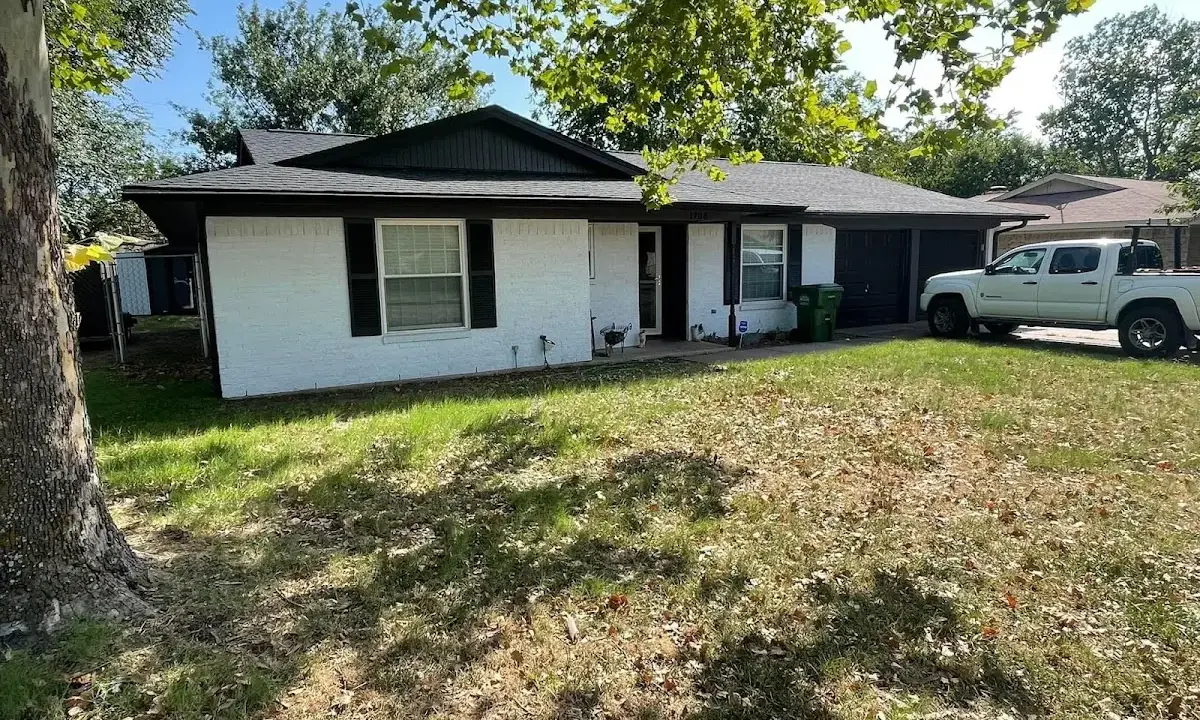 Professional roofing crew working on a residential roof in Niles